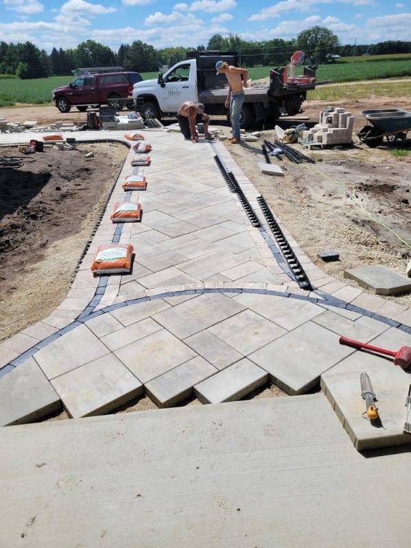 Janesville WI paver walkway installation featuring curved edges and contrasting border pavers.