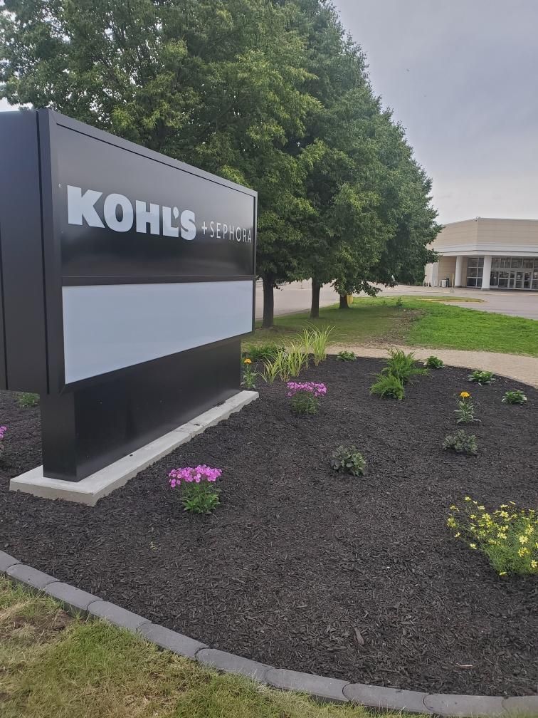 Renovated Kohl’s and Sephora landscape bed with fresh mulch, edging, and colorful plantings in Janesville, WI.
