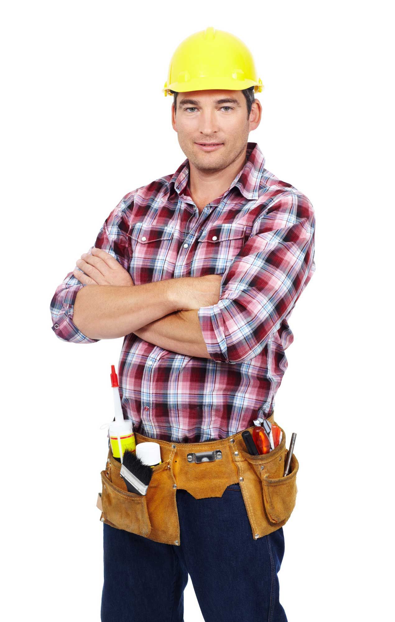 Construction worker in yellow hard hat, plaid shirt, tool belt, arms crossed.