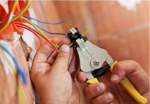 A person is using a wire stripper to strip wires