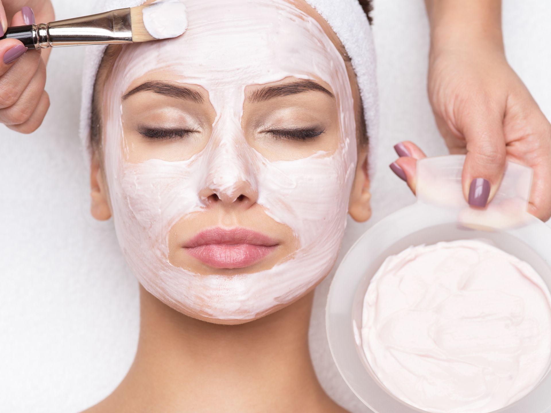 A woman is getting a facial treatment at a spa.