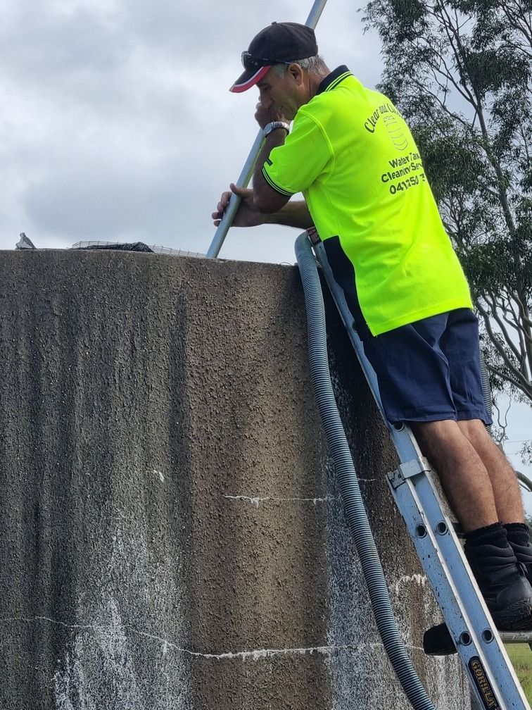 A Group Of Stainless Steel Water Tanks Are Sitting On Top Of A Roof — Clear and Clean Water Tank Cleaning Services in Bridgman, NSW