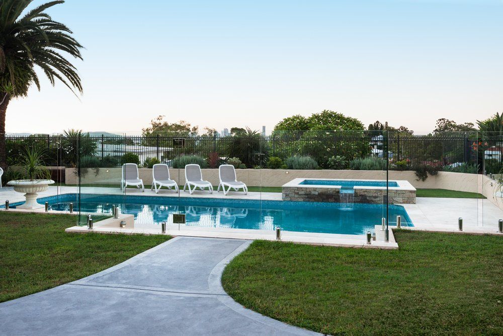 Pathway to a Modern Swimming Pool Through the Green Grass Lawn — Skilled Fibreglass Pool Repairs in Darwin, NT