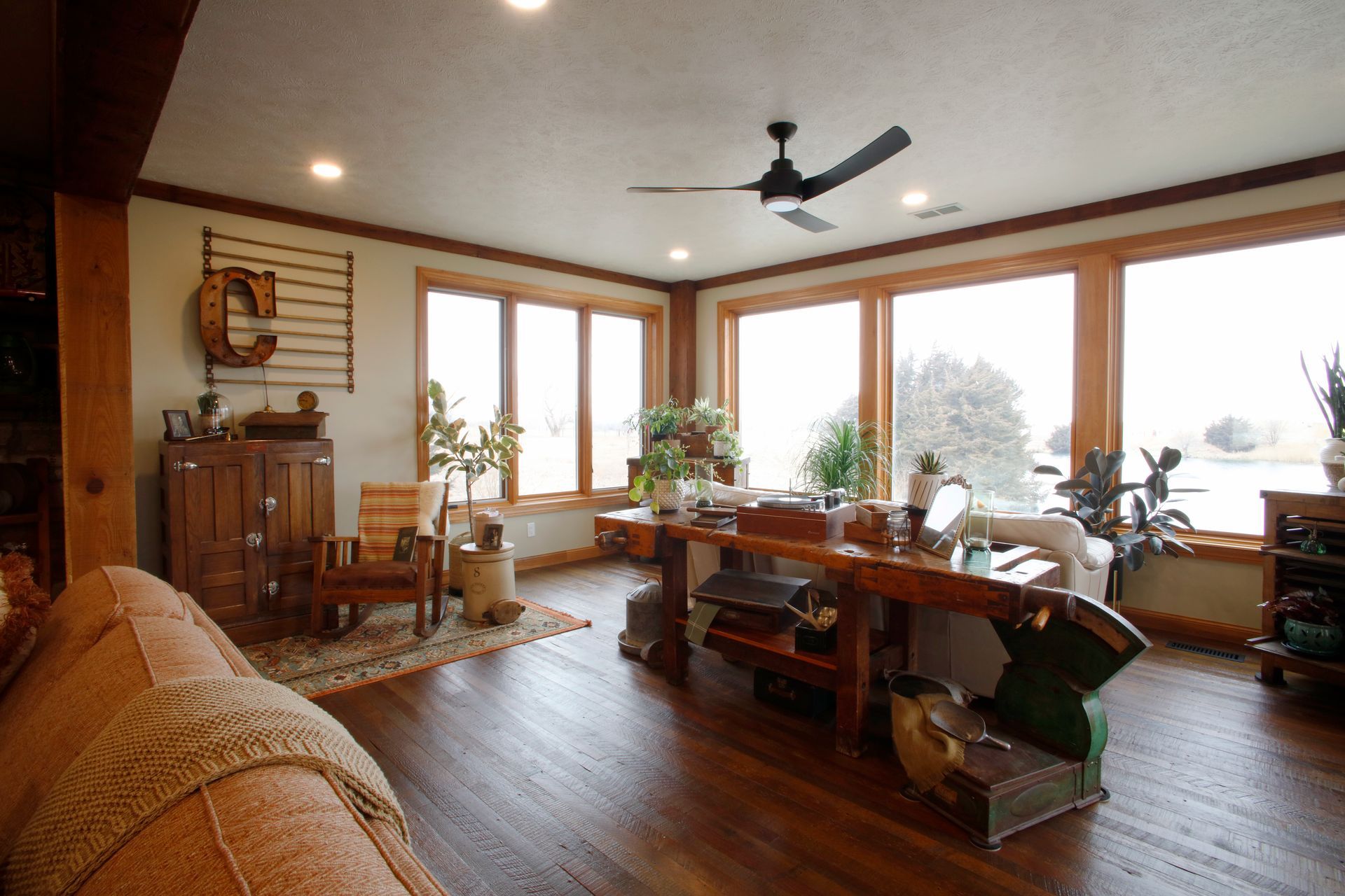 Wooden workshop with workbench, steps, and windows. Interior view with concrete floor.