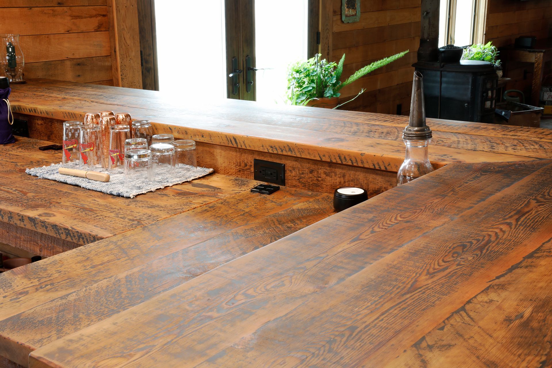 Spacious, open-concept living space with dark wood floors, kitchen island, and a fireplace.