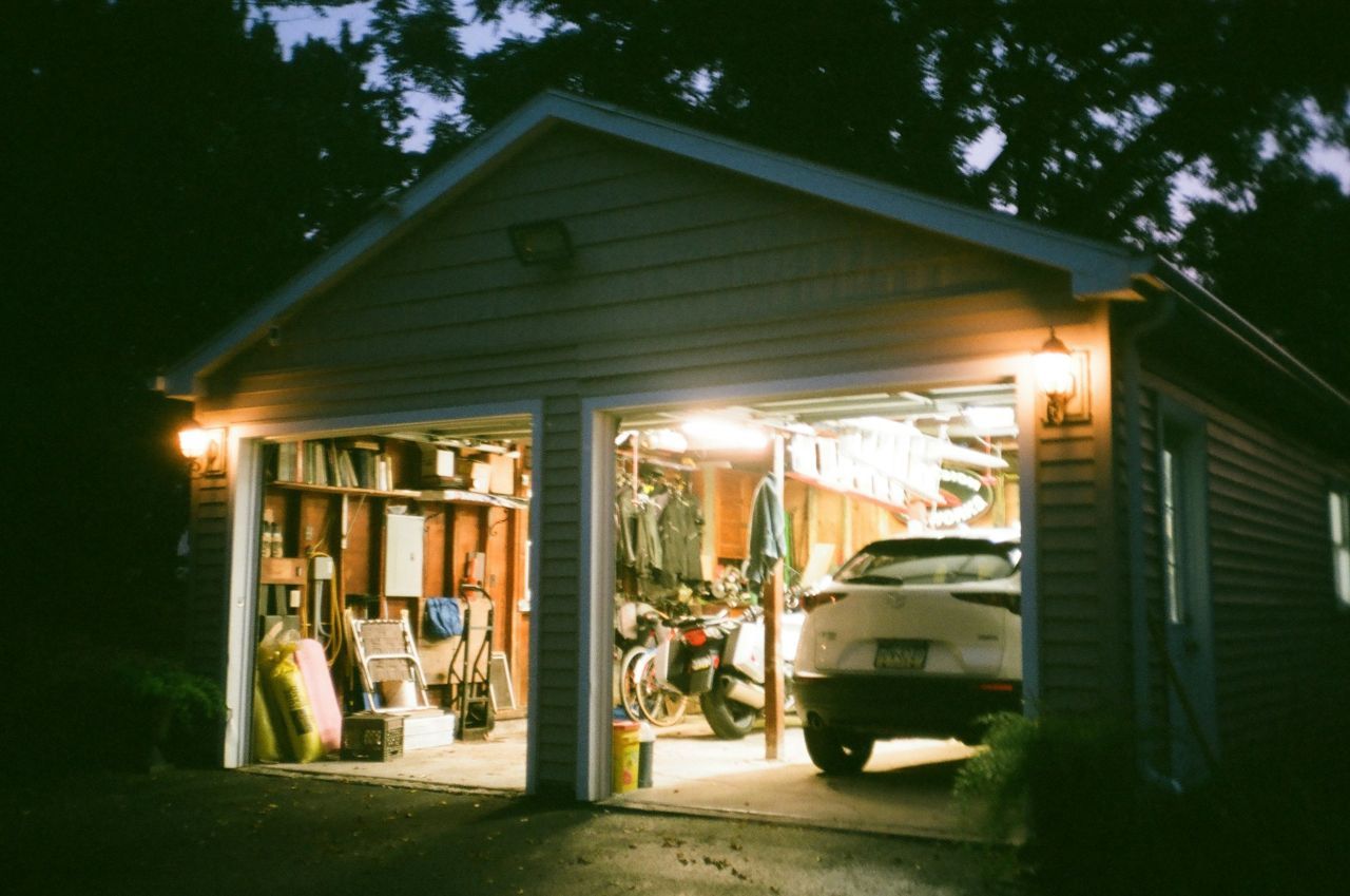 A large shed turned into a garage, with a car parked inside