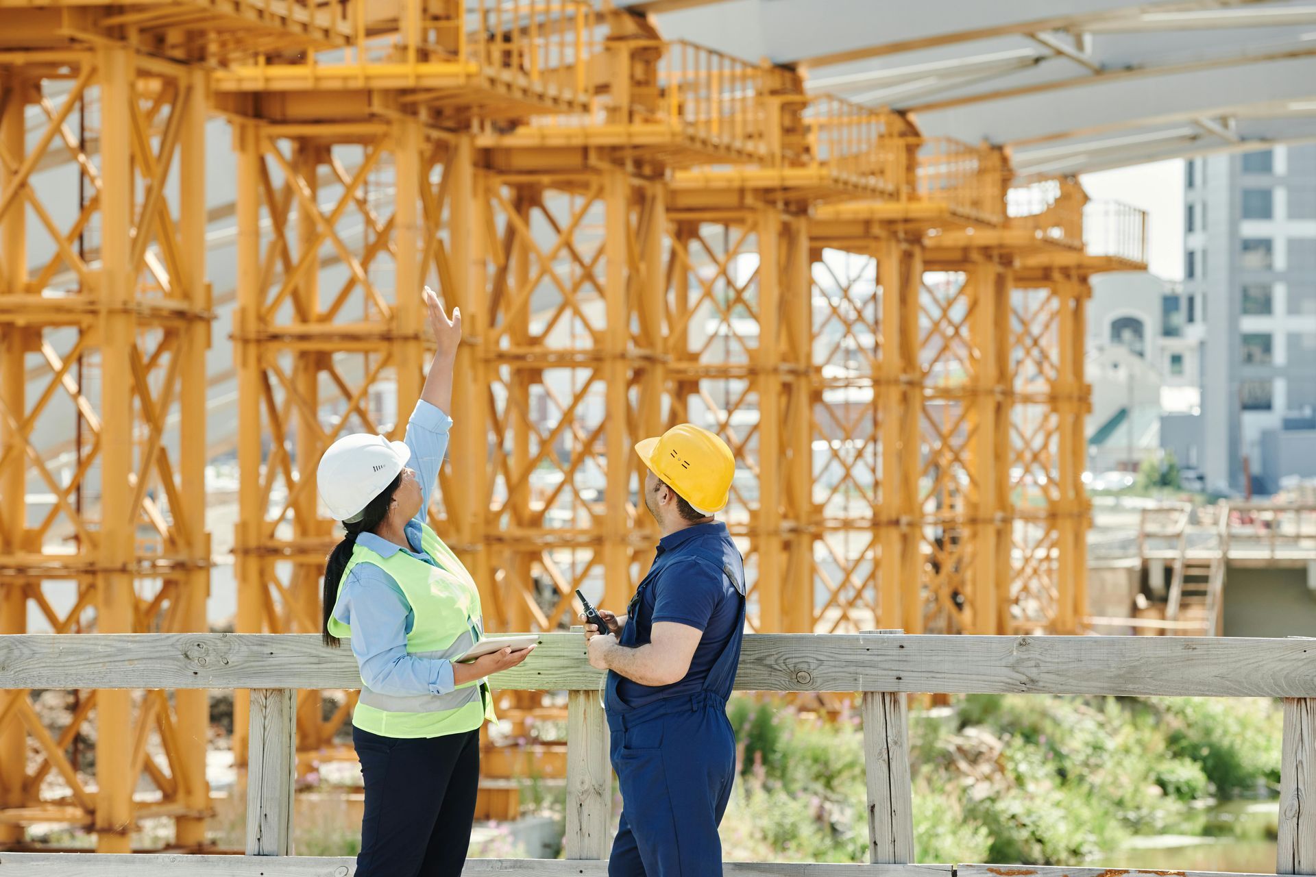 Deux ouvriers du bâtiment se tiennent côte à côte sur un chantier de construction.