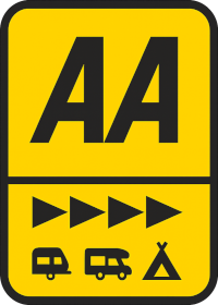 A yellow road sign with the letters