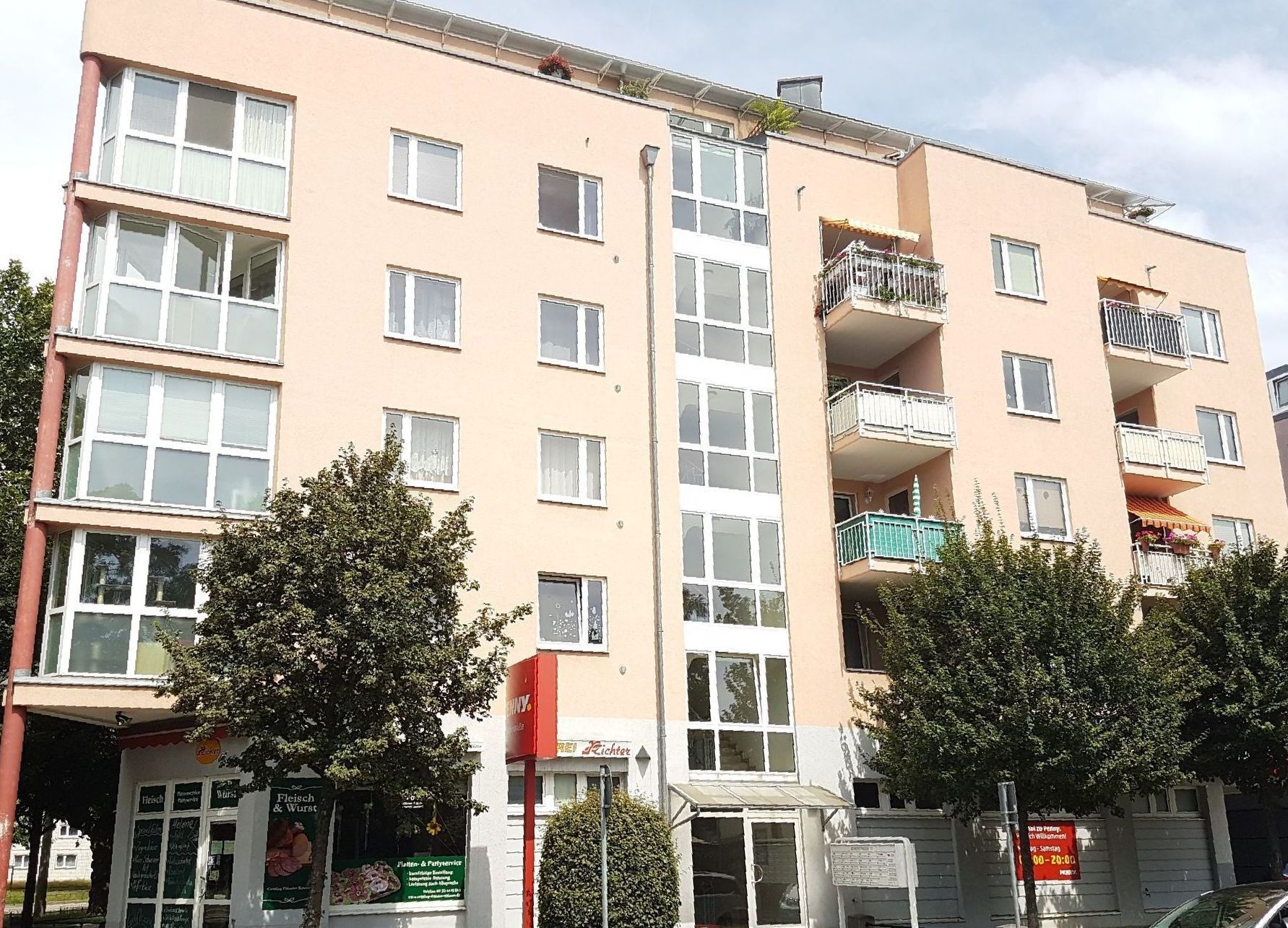 Ein großes Mehrfamilienhaus mit vielen Fenstern und Balkonen