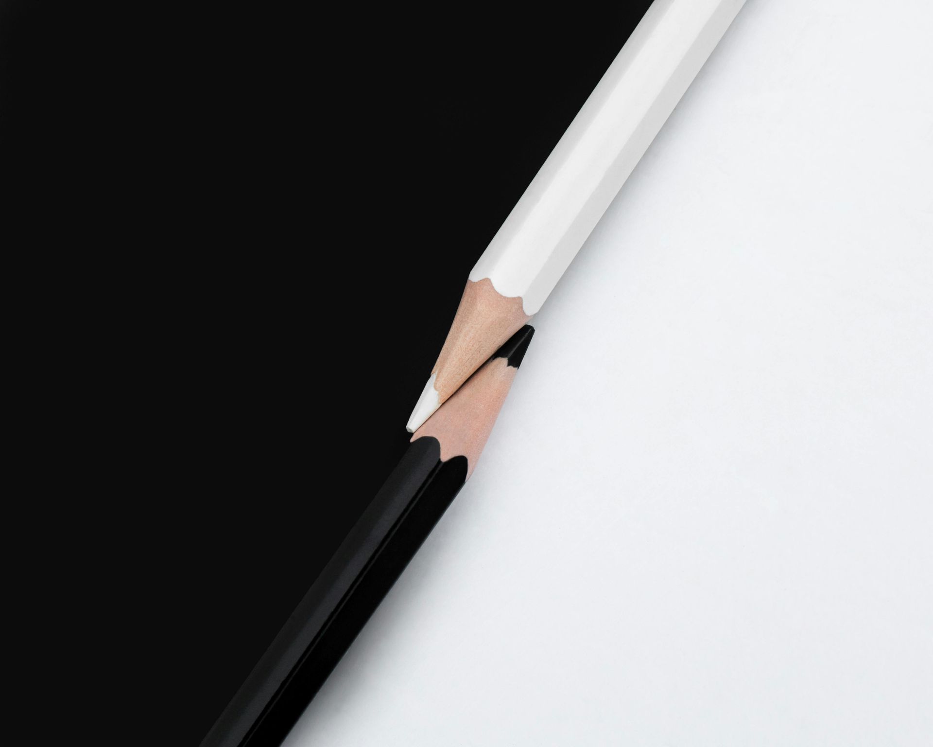 A black and white pencil is broken in half