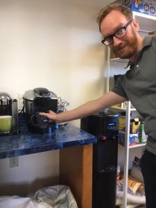 Ryan reaches for Donut Shop coffee.
