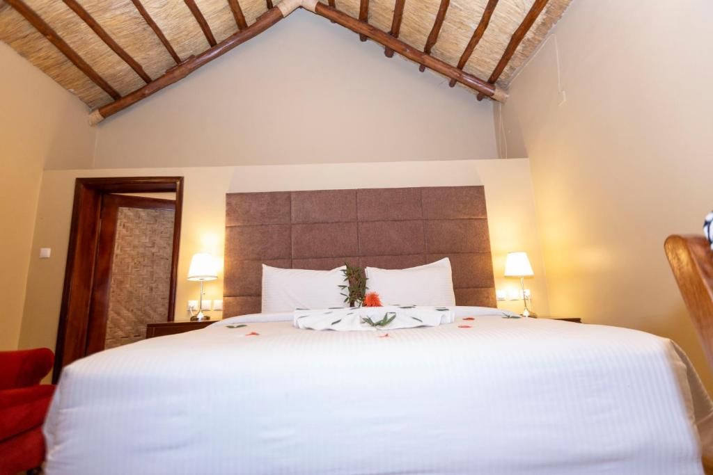 King-size bed decorated for honeymoon couple at akagera safari camp
