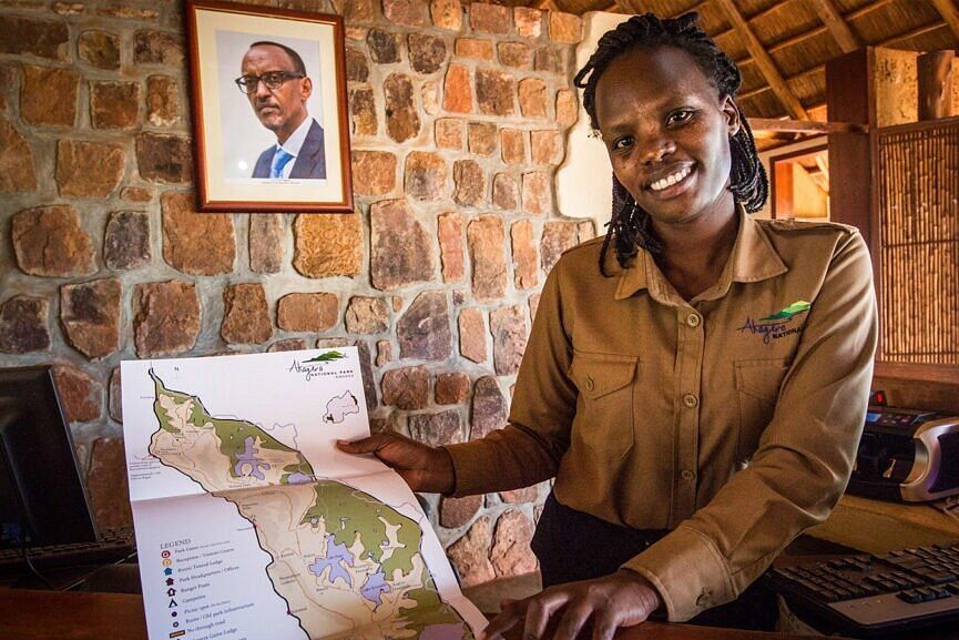 Akagera National Park ranger at the reception holding the official park map at the entrance gate