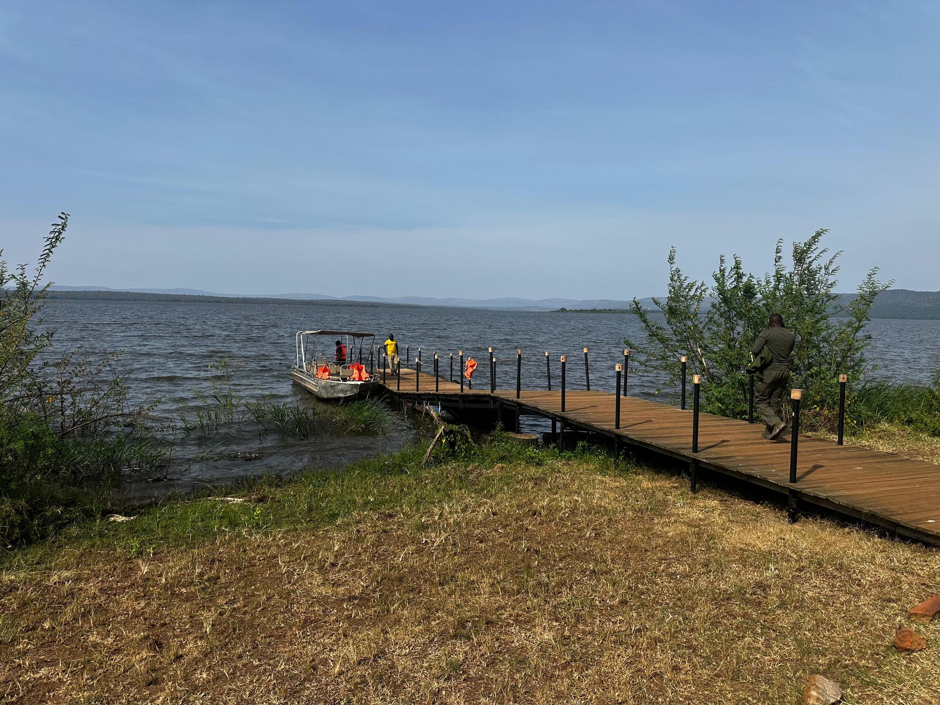 Boat launch jetty on Lake Ihema with a safari boat docked
