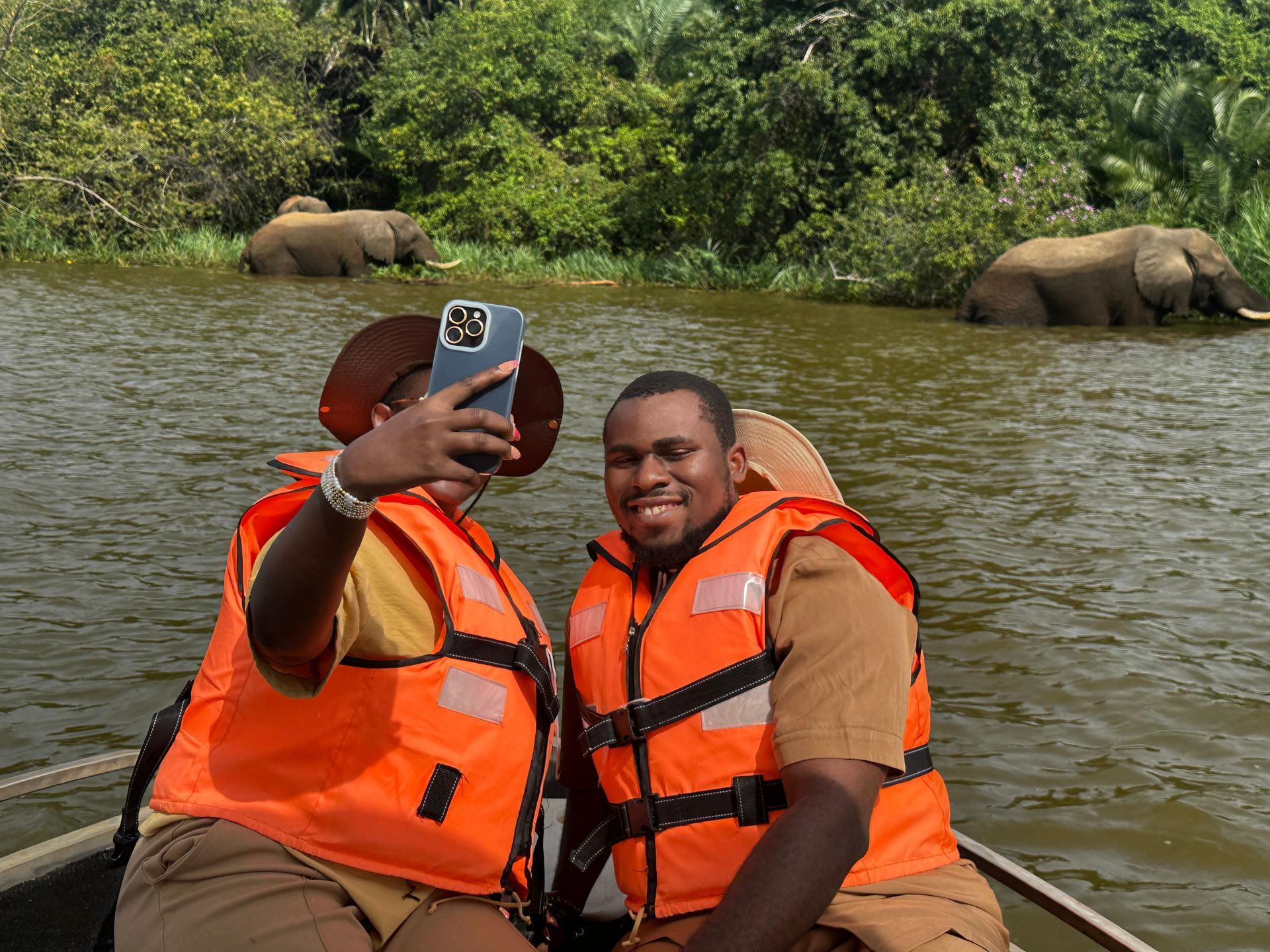 Two guests in life jackets taking a selfie on the morning boat safari