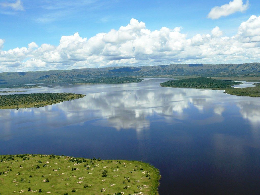 Akagera National Park aerial view of Lake Ihema with cloud reflections wooded islands and sandstone ridge western boundary eastern Rwanda