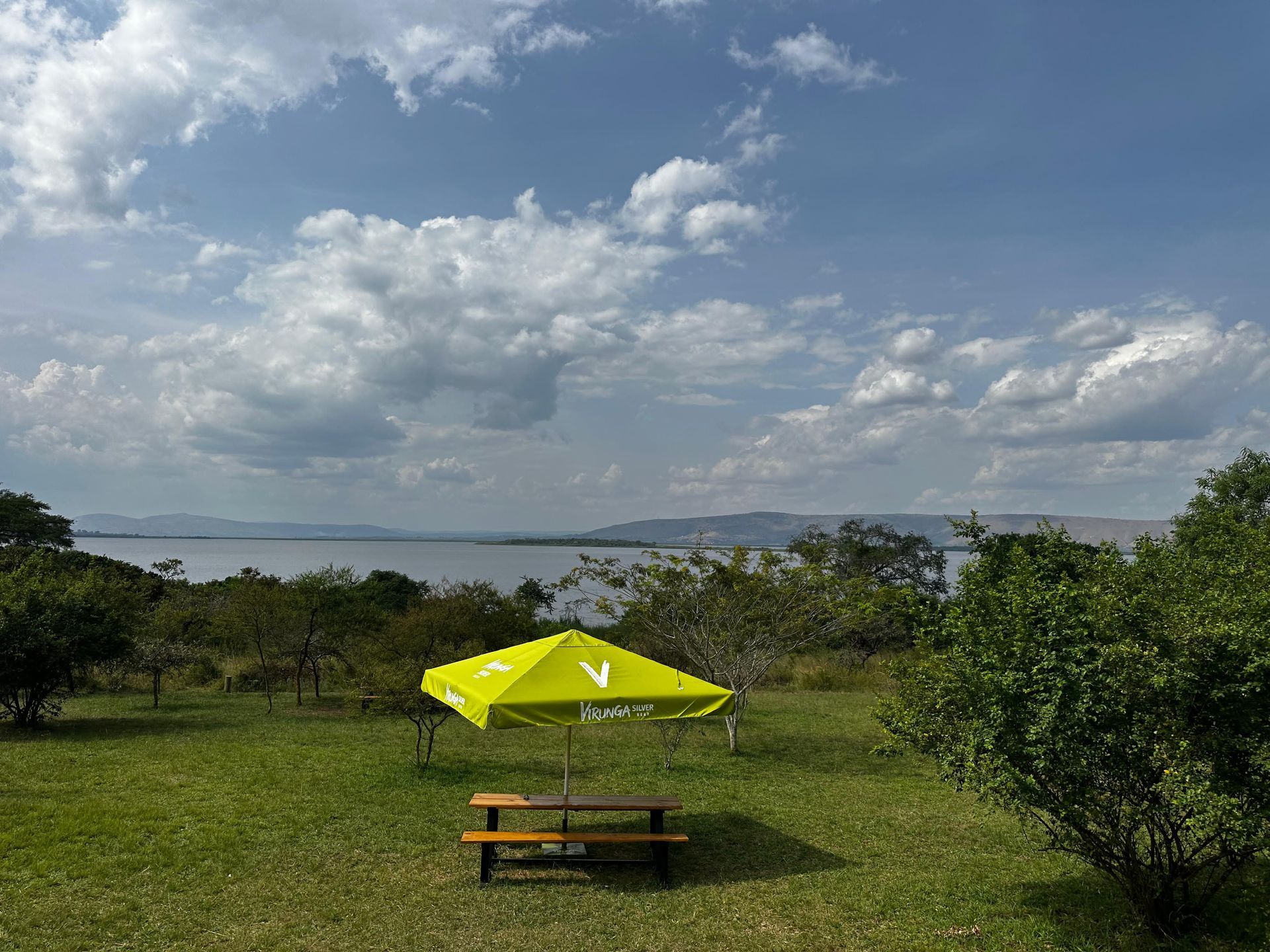 Picnic table and umbrella at a lakeside rest stop in Akagera National Park