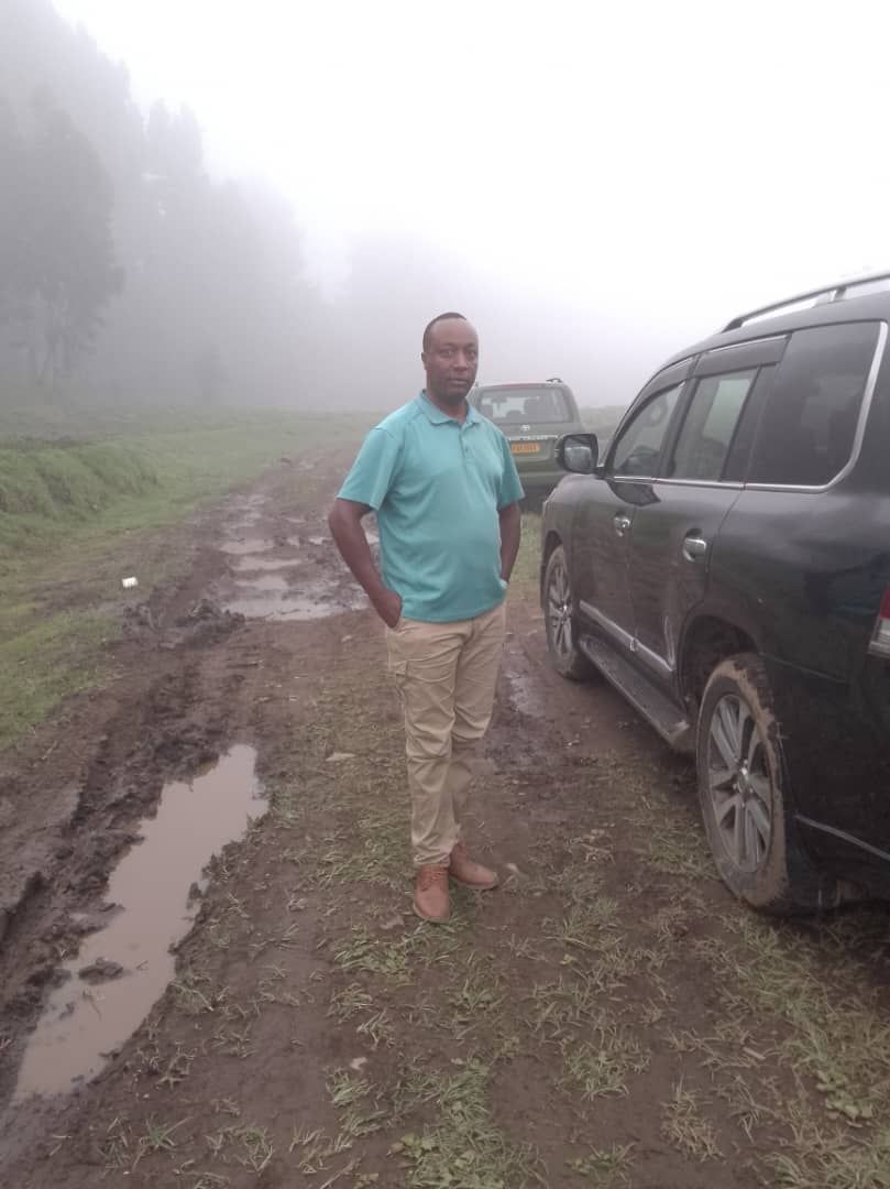 Driver with 4x4 vehicle on rough volcanic road to Volcanoes National Park Rwanda trailheads