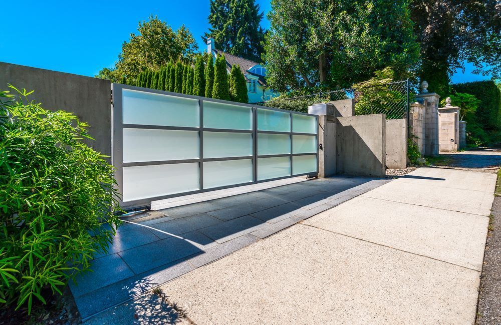 A Sliding Gate is Open in Front of a House — Airlie Beach Garage Doors In Airlie Beach, QLD