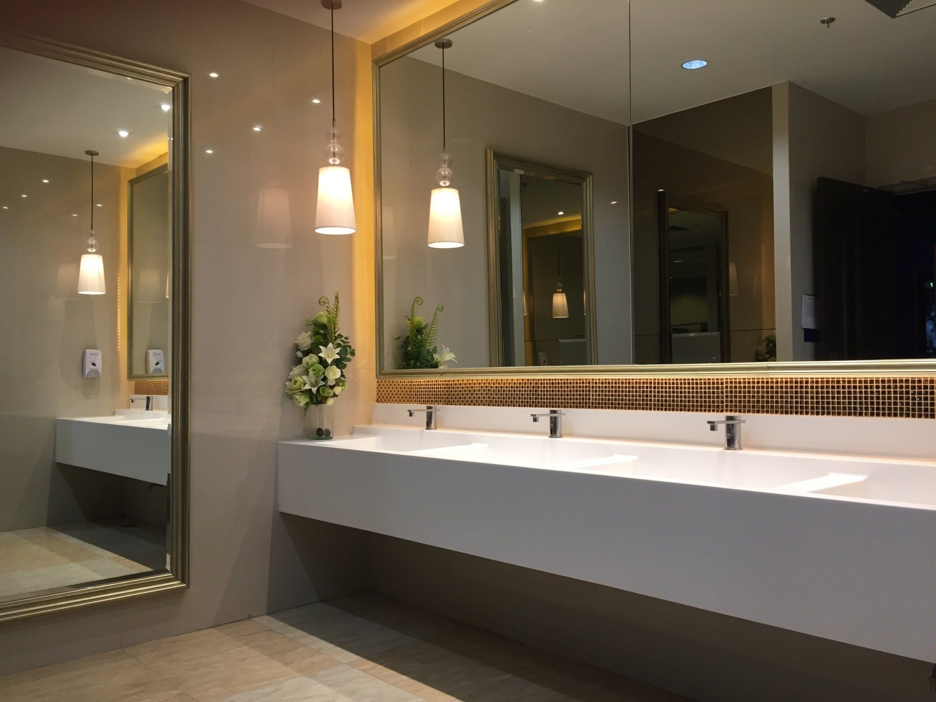 A bathroom with two sinks and a large mirror