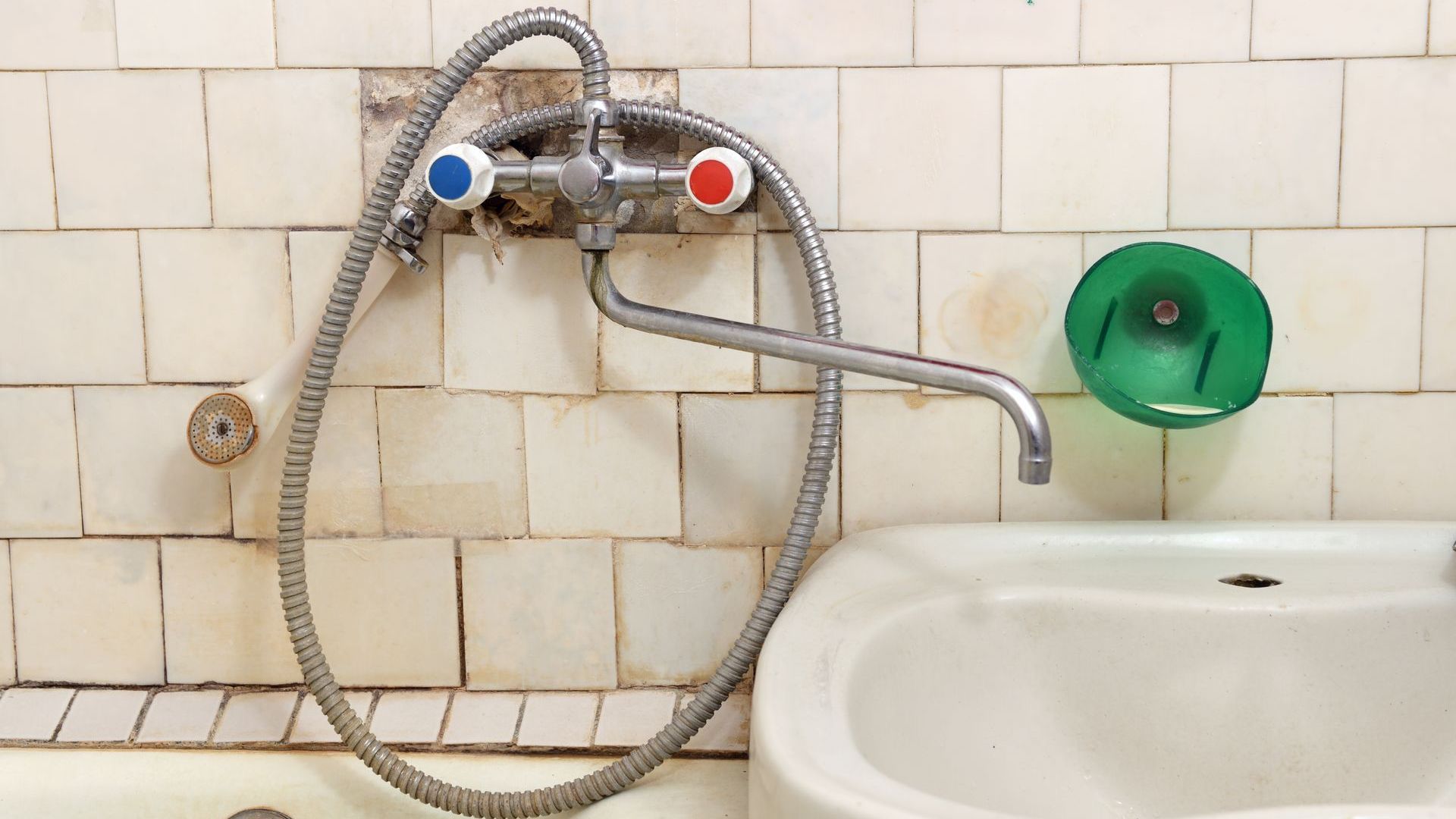A bathroom sink with a hose attached to it
