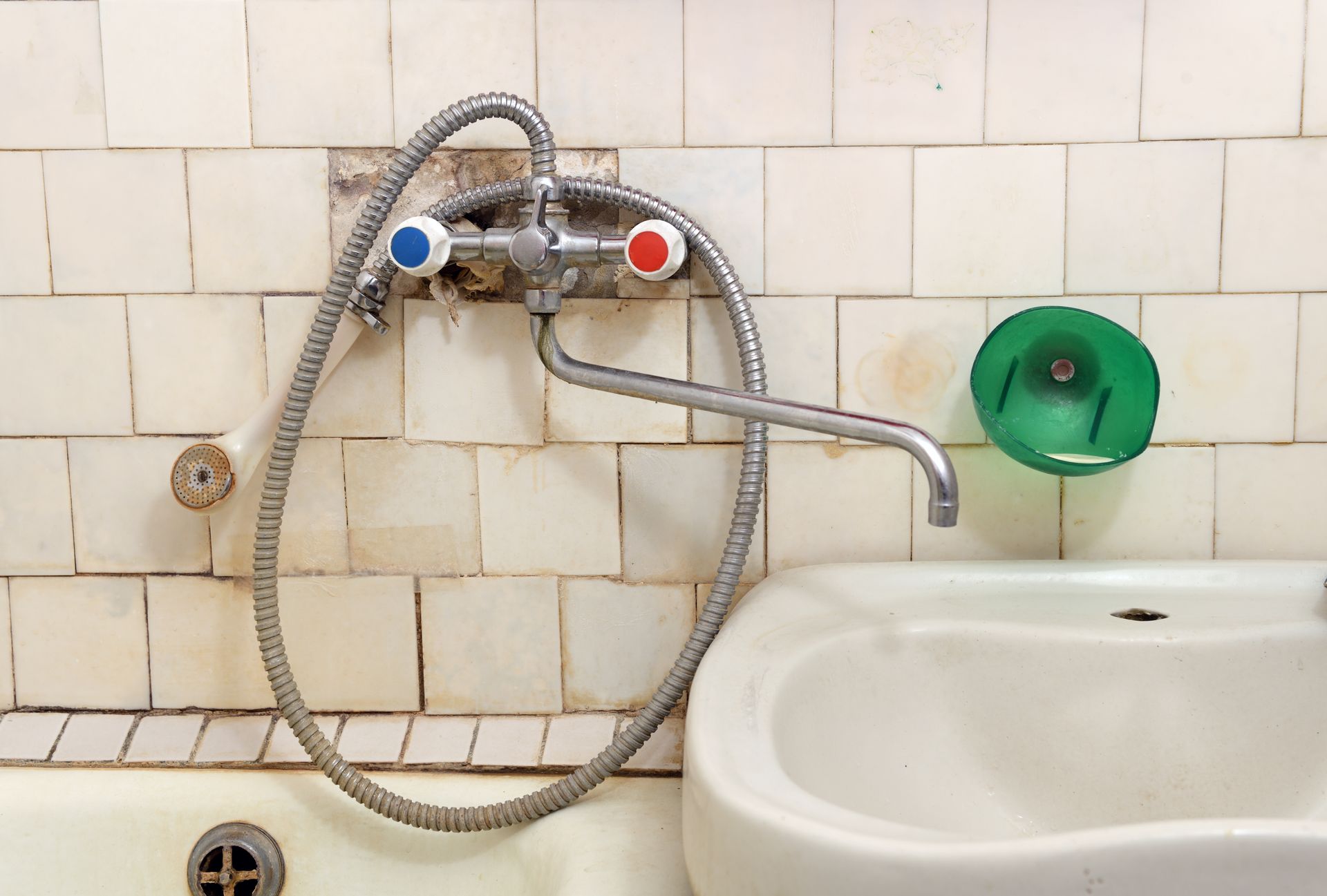 A bathroom sink with a shower head attached to it