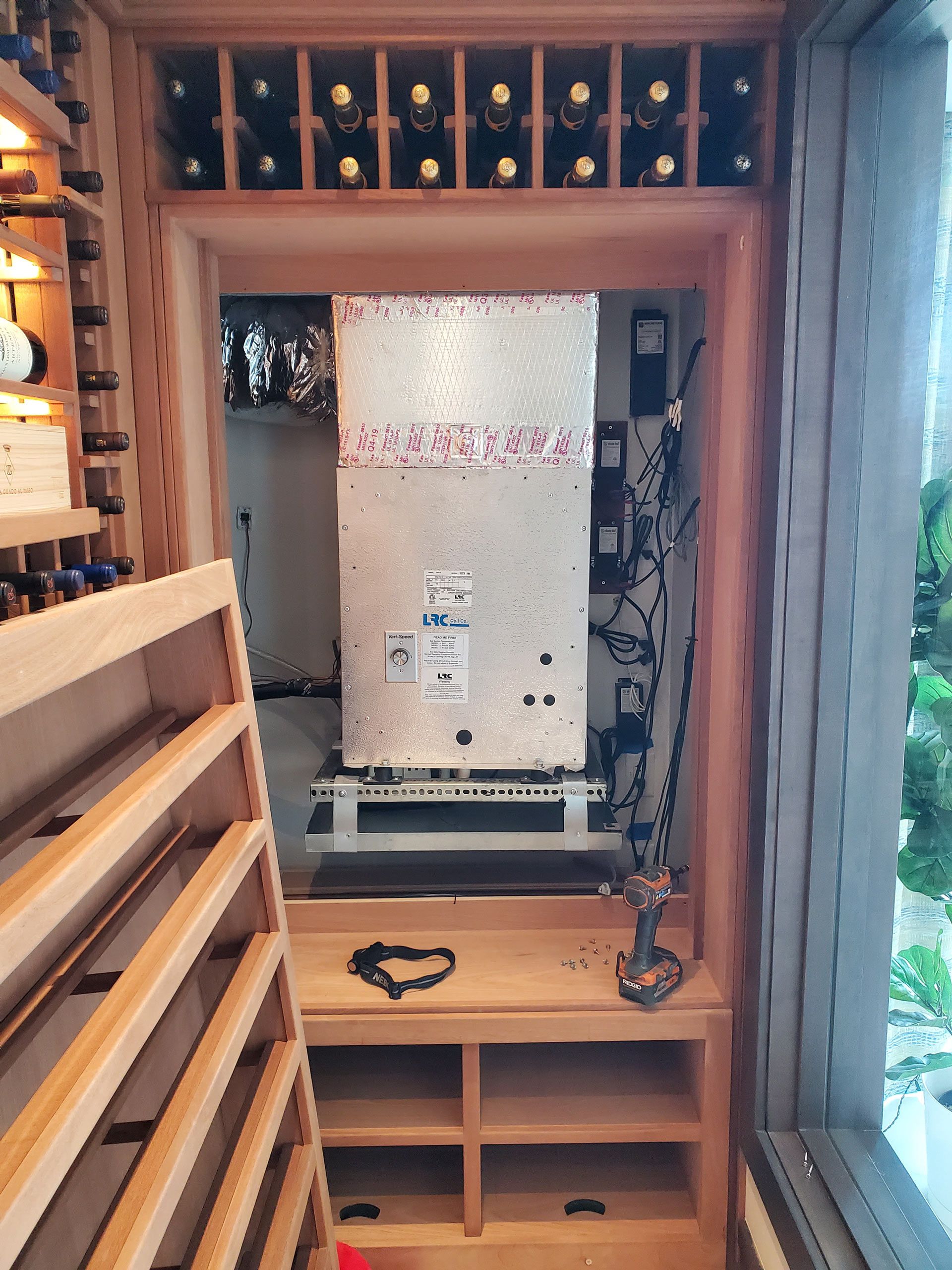 The inside of a wine cellar with bottles on shelves