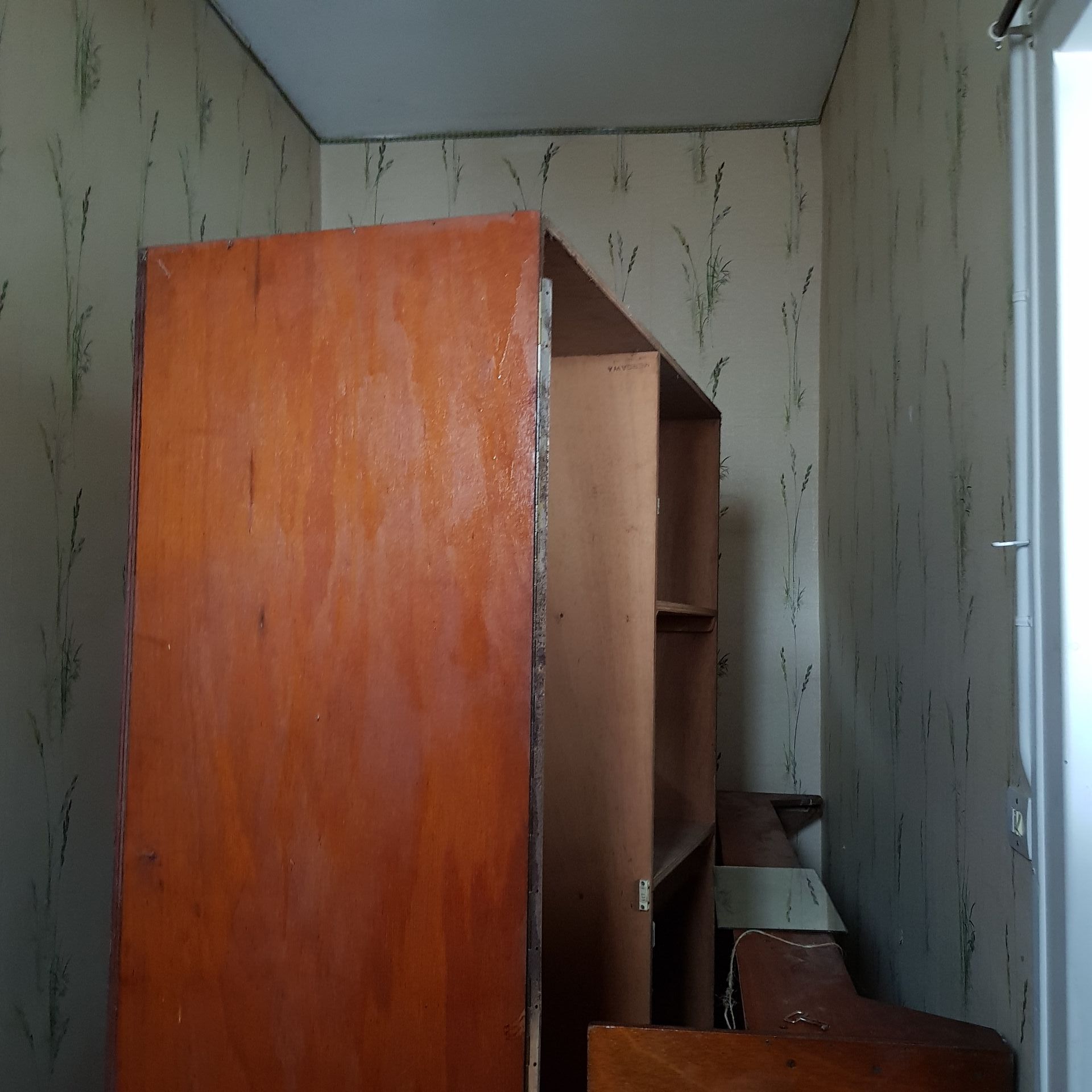 side room with a large broken wardrobe