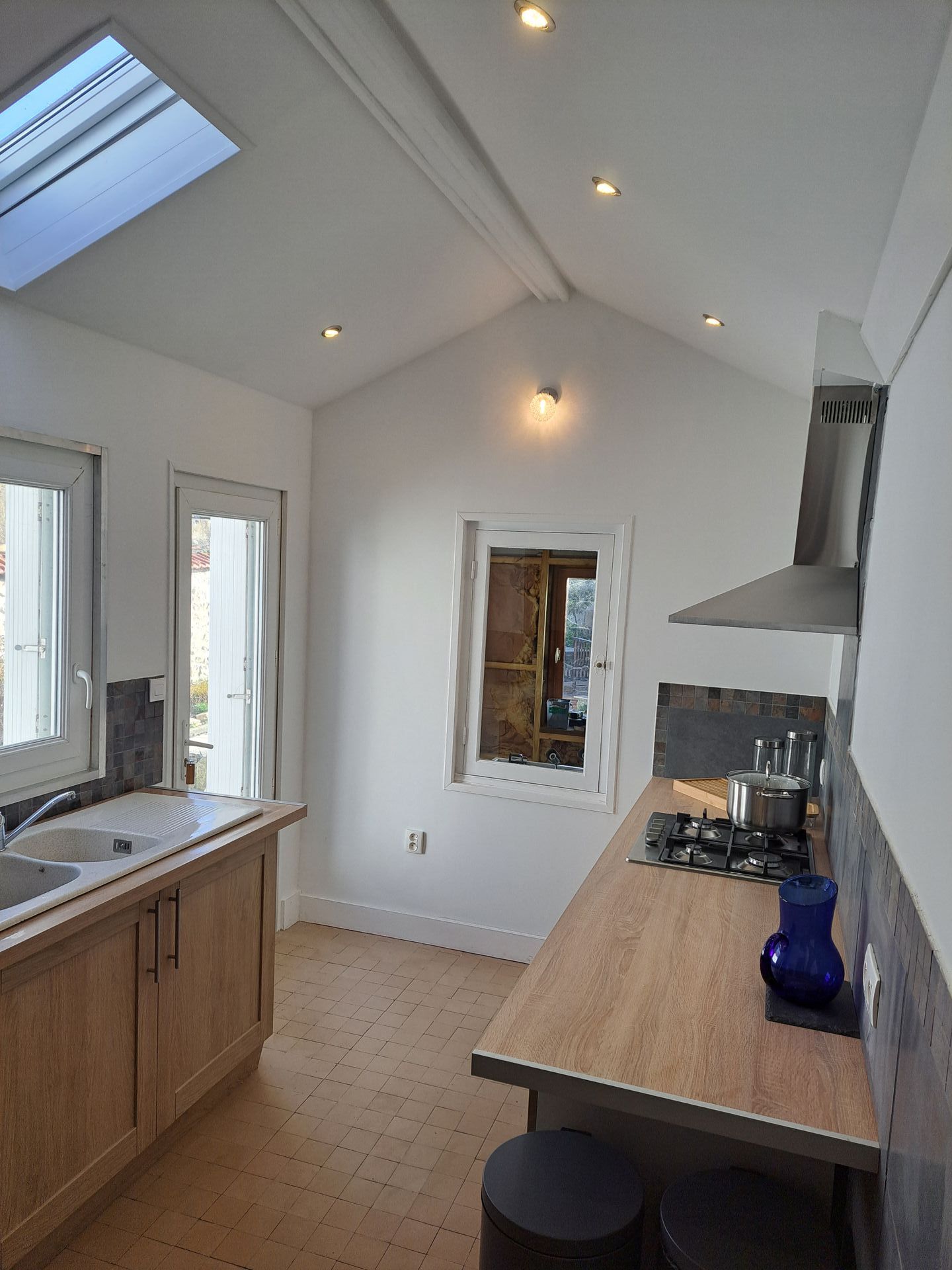 kitchen after renovation with fresh white walls, new work tops and cupboards