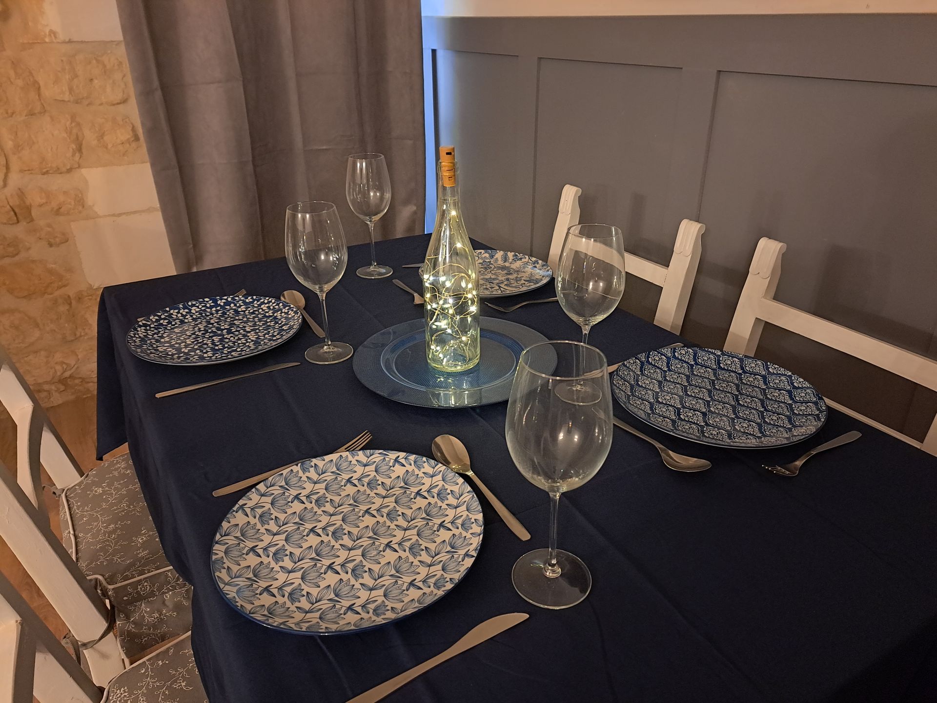 dining table with dark blue tablecloth and blue white patterned plates