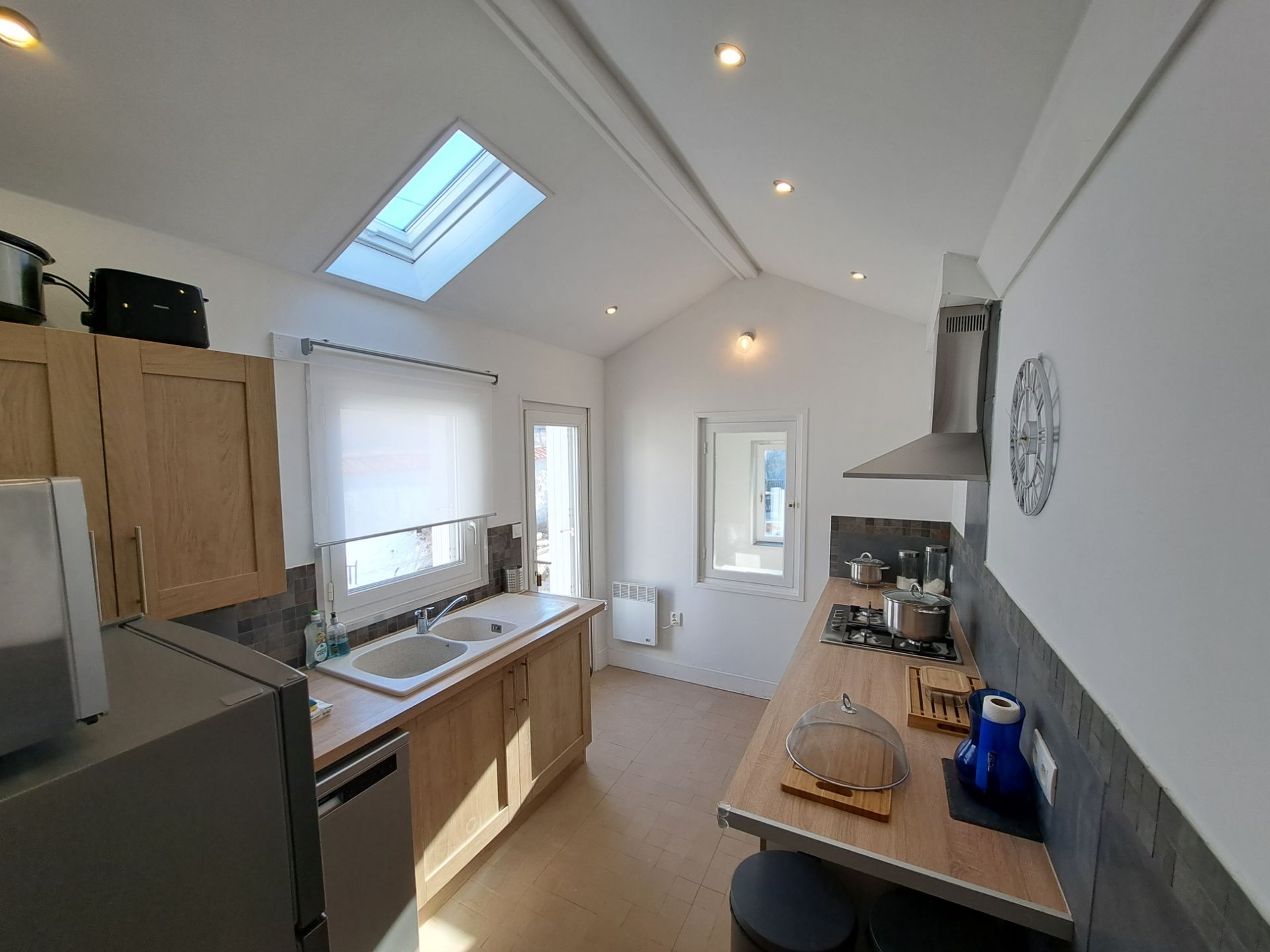 kitchen with white walls and light oak effect units and worktop