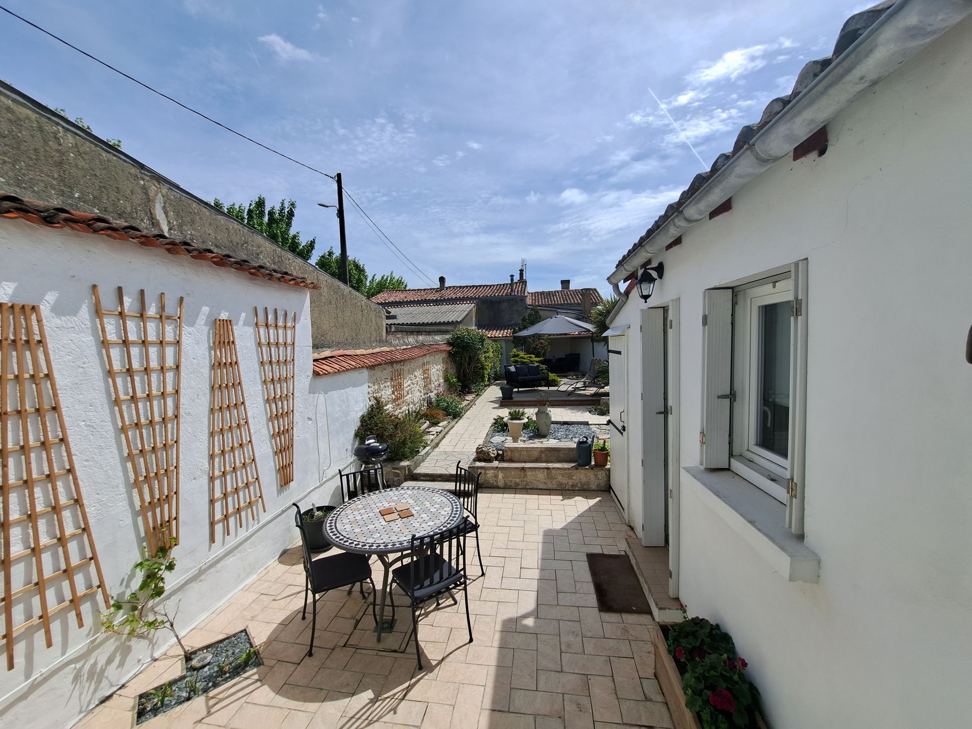 walled garden with tiled patio and walkways