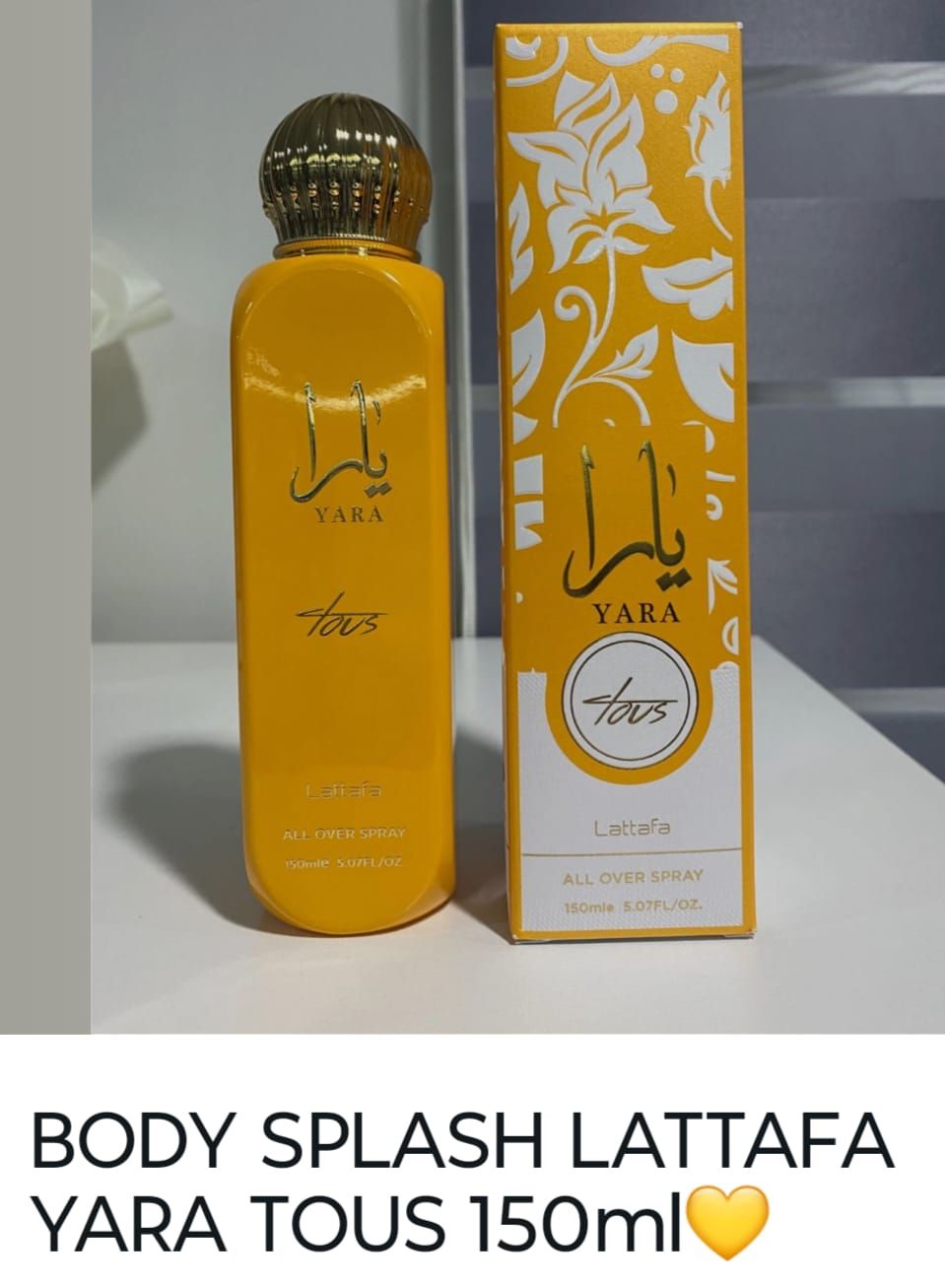 Lattafa Yara Tous, botella y caja en envase amarillo y blanco.