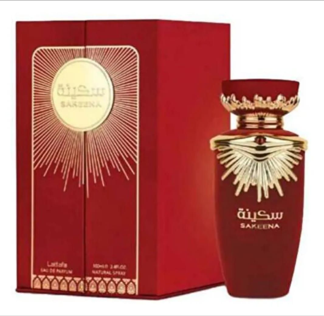 Estuche de regalo de perfume de lujo en color granate y dorado con frasco ornamentado y empaque a juego, exhibido abierto.