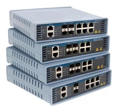 Stack of four gray network switches with multiple Ethernet ports