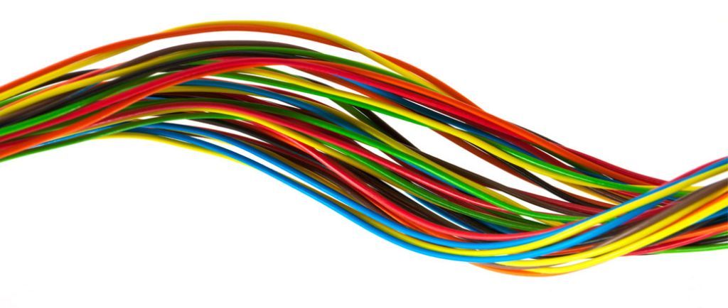 Colorful twisted rainbow wires on a white background