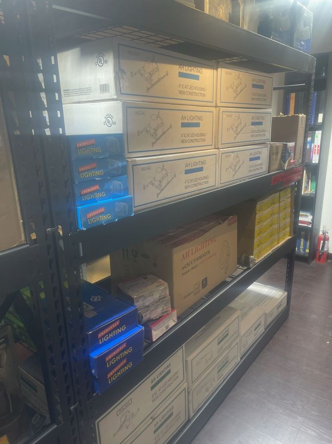 Shelves stocked with stacked cardboard boxes in a store aisle
