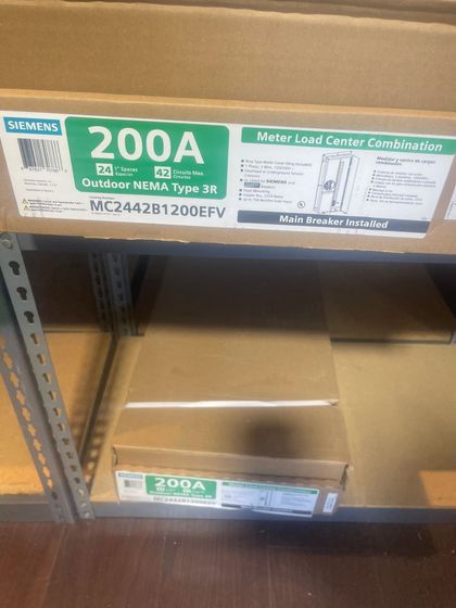 Shelf with large electrical boxes labeled 200A in a warehouse aisle