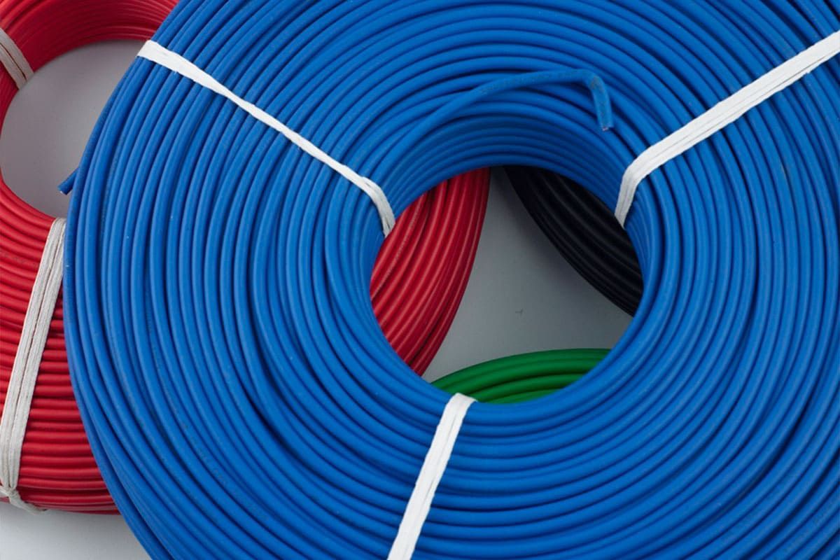 Coiled blue hoses bound with white straps, with red and green hoses visible behind them