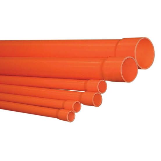 Stack of bright orange plastic pipes or tubes on a white background