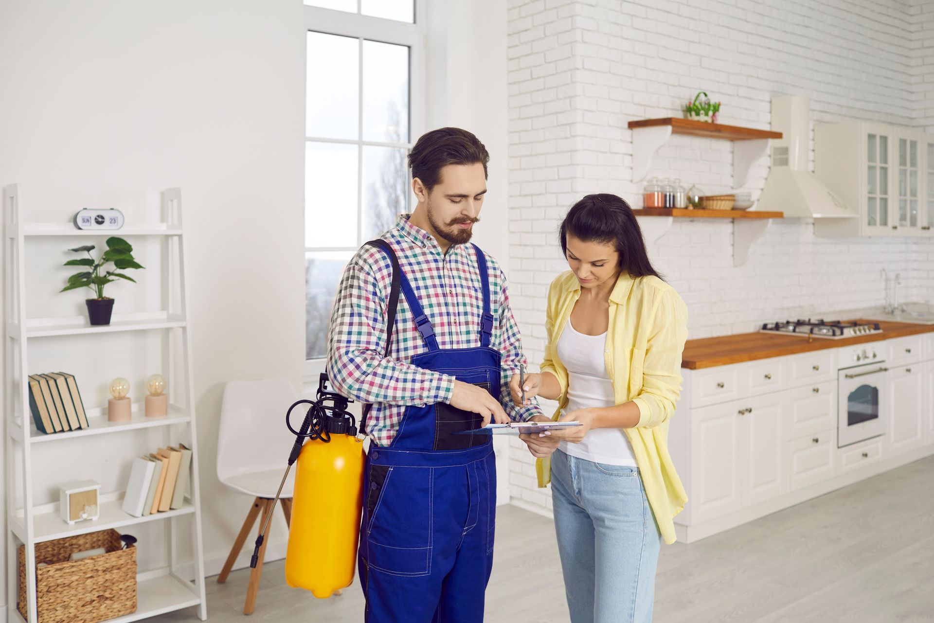 An exterminator is talking to a woman. An exterminator is talking to a woman.