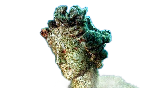 Sculpted stone face with a curly greenish headdress, shown in profile against a white background