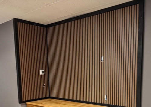 Empty room with blue walls and carpet, white ceiling with recessed lights, and two white doors.