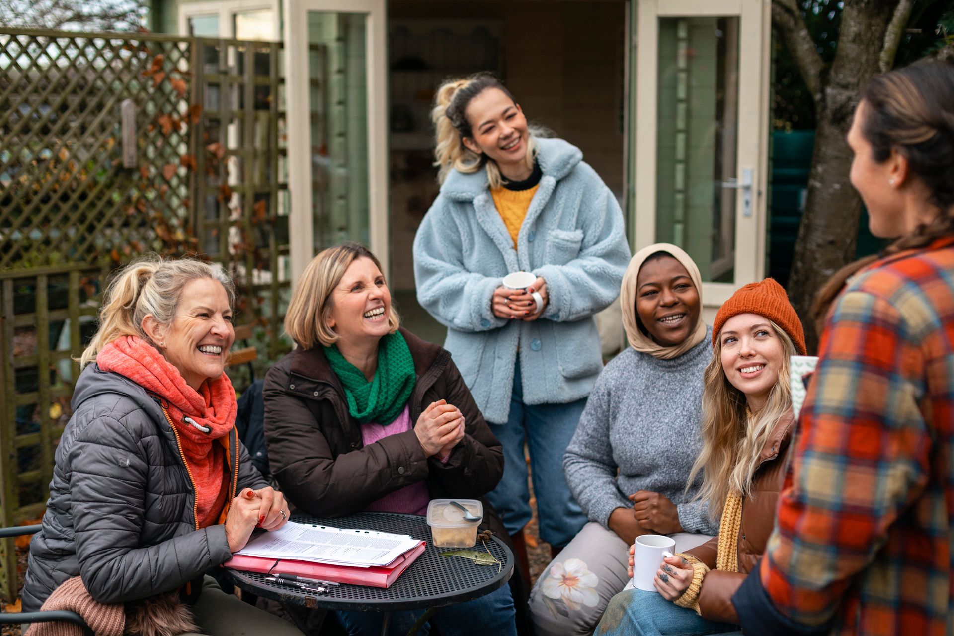 Volunteers Sitting Outdoors — Houma, LA — Dr. Charon Gentile and Heather