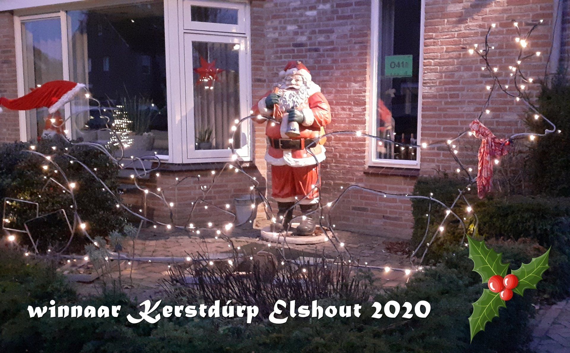 Festive outdoor Christmas display with Santa statue, lights, and 