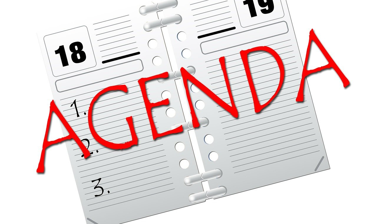 Agenda in een open notitieboek; datums 18 en 19 zichtbaar, genummerde agendapunten in lijstvorm.