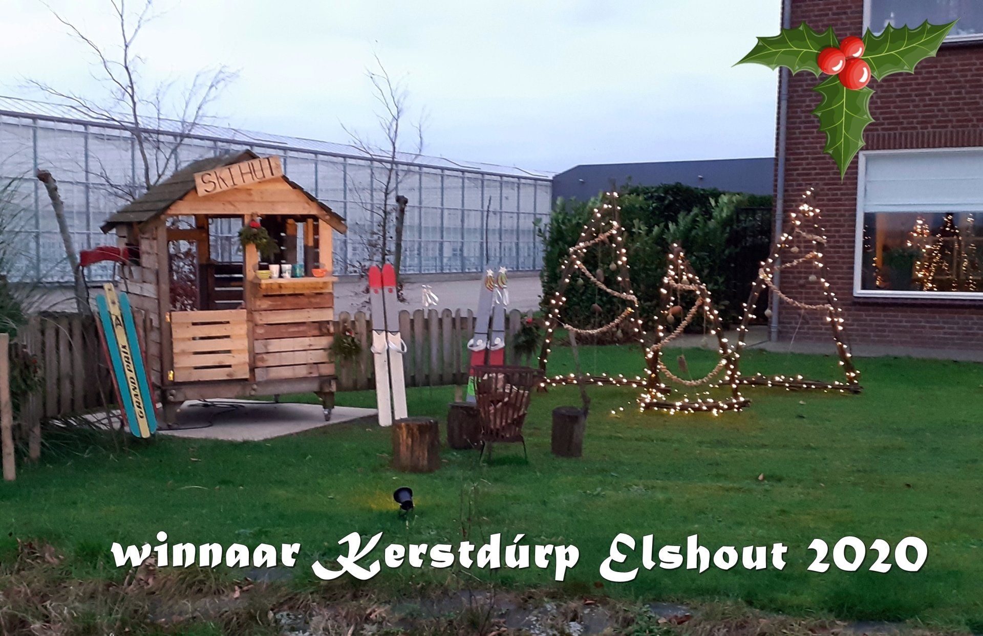 A Christmas scene with a playhouse, lit trees, and the text 