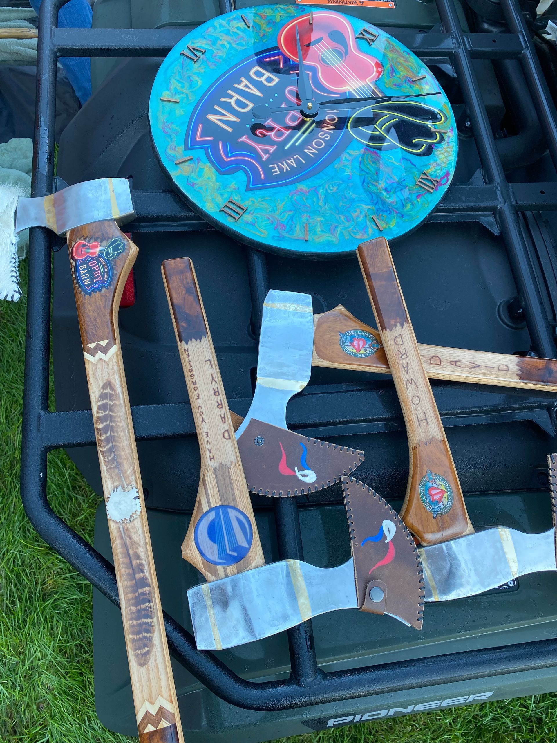 Four handmade cardboard dinosaur cutouts on a black surface, one blue circular dinosaur decoration at top.