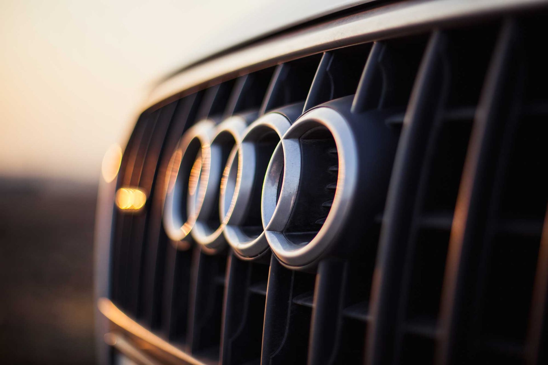 A close up of an audi logo on the front of a car