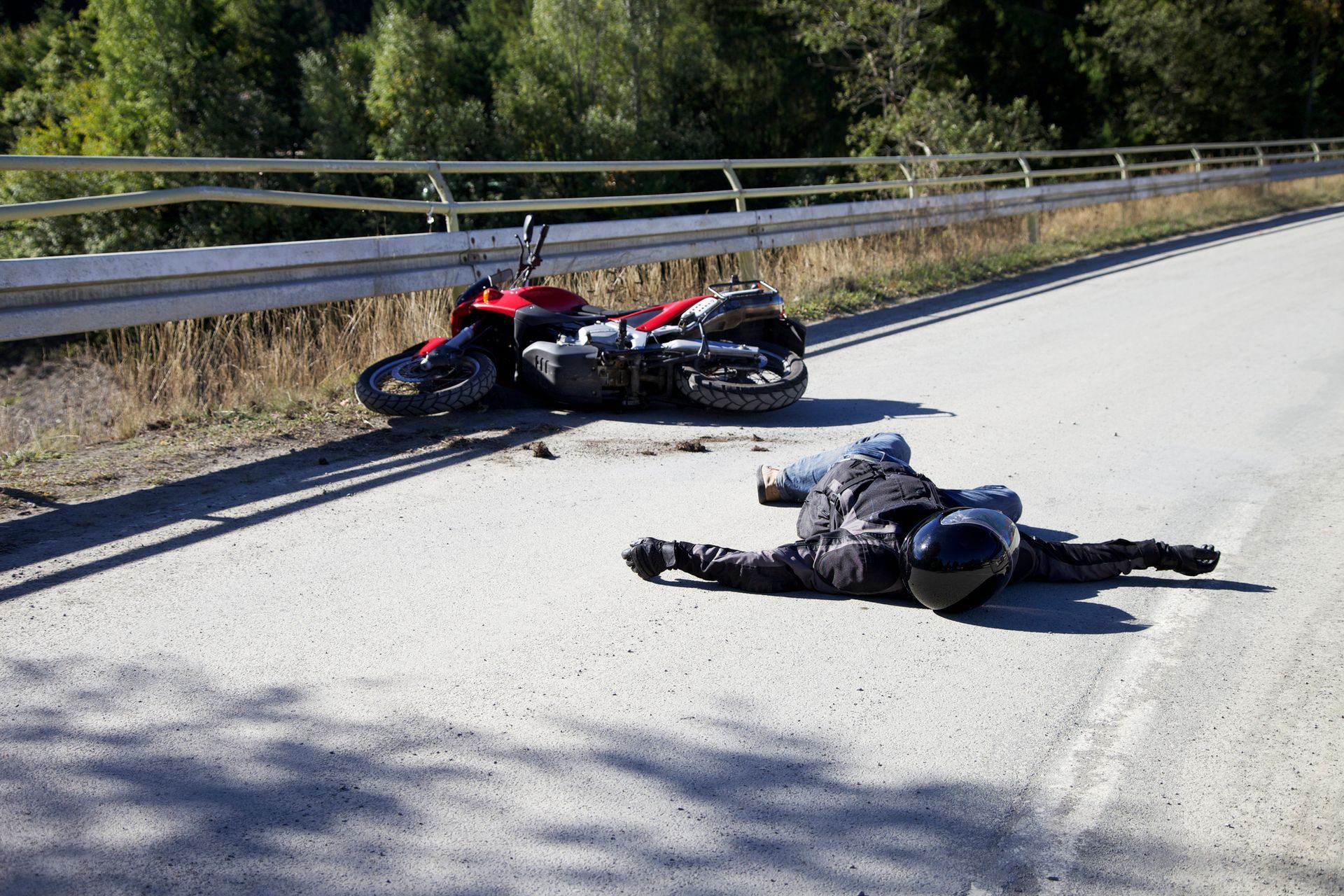 Injured man needing medical help and a motorcycle accident attorney after a crash in Geneva, OH.
